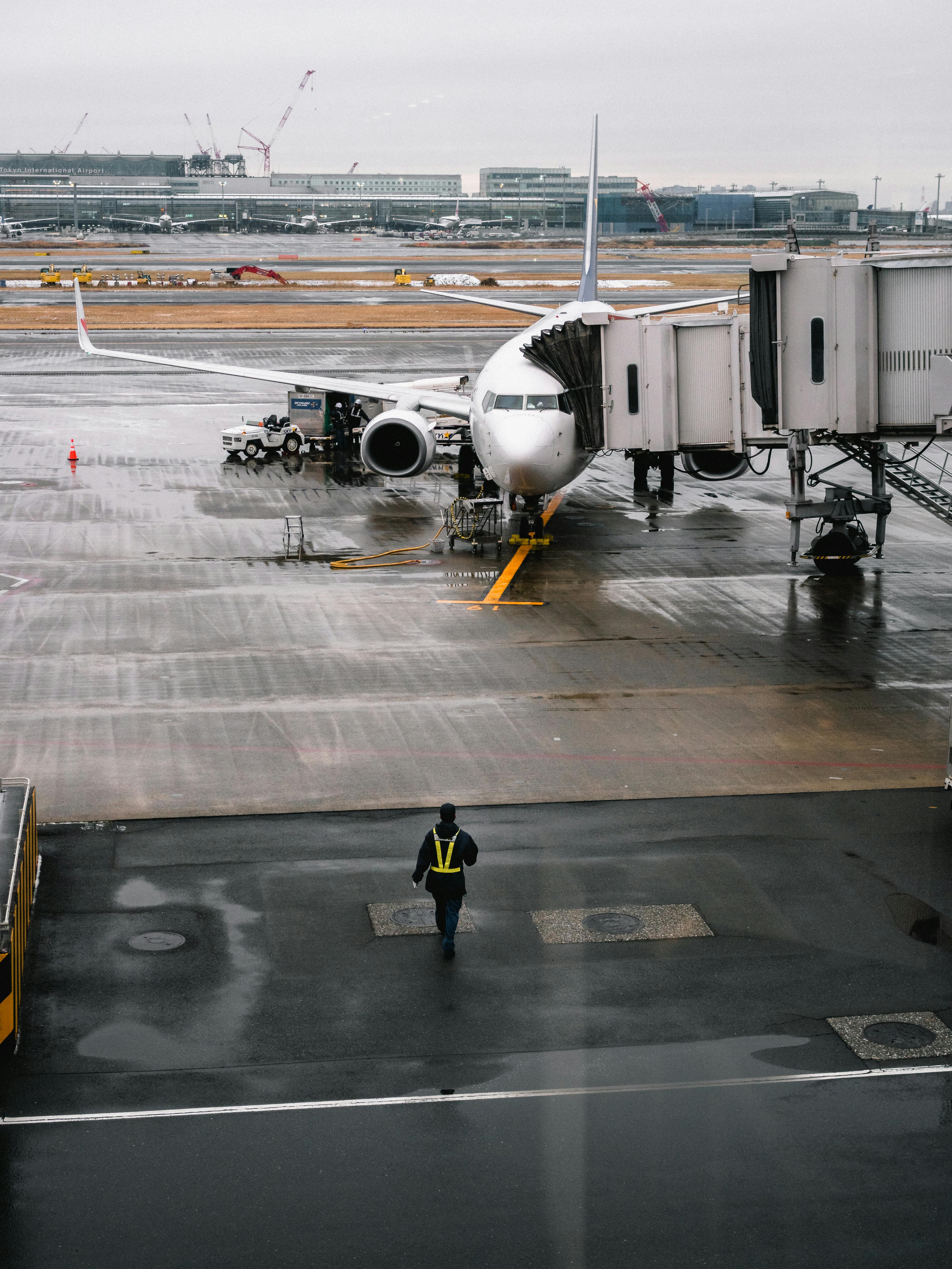 a man walking next to an airplane